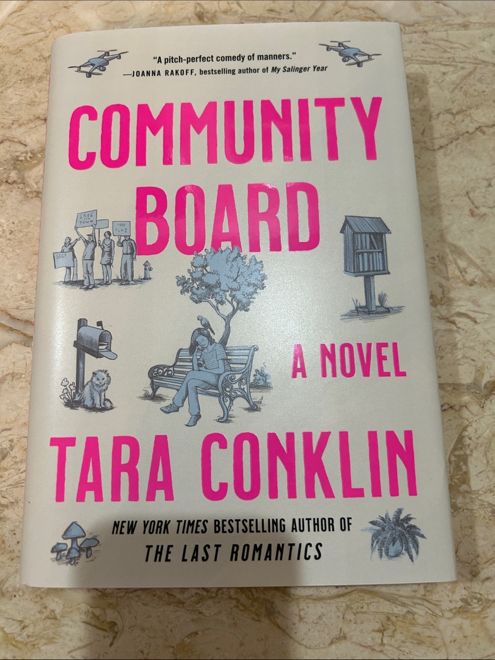 Community Board by Tara Conklin - Cream Cover with Bright Pink Title